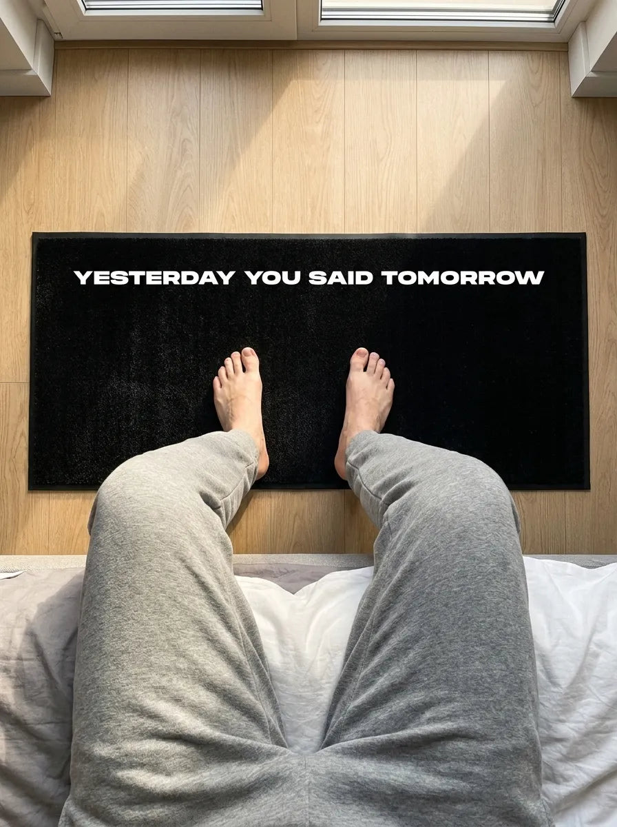 Custom text mat beside a bed, first person view