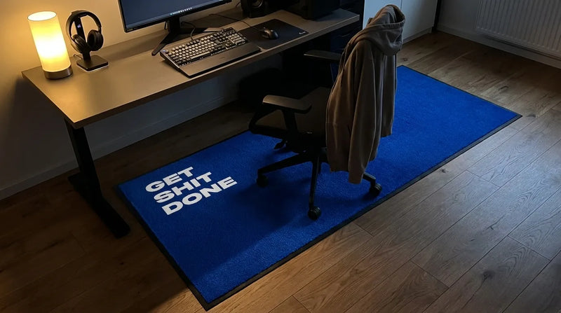 Blue custom text mat under a desk